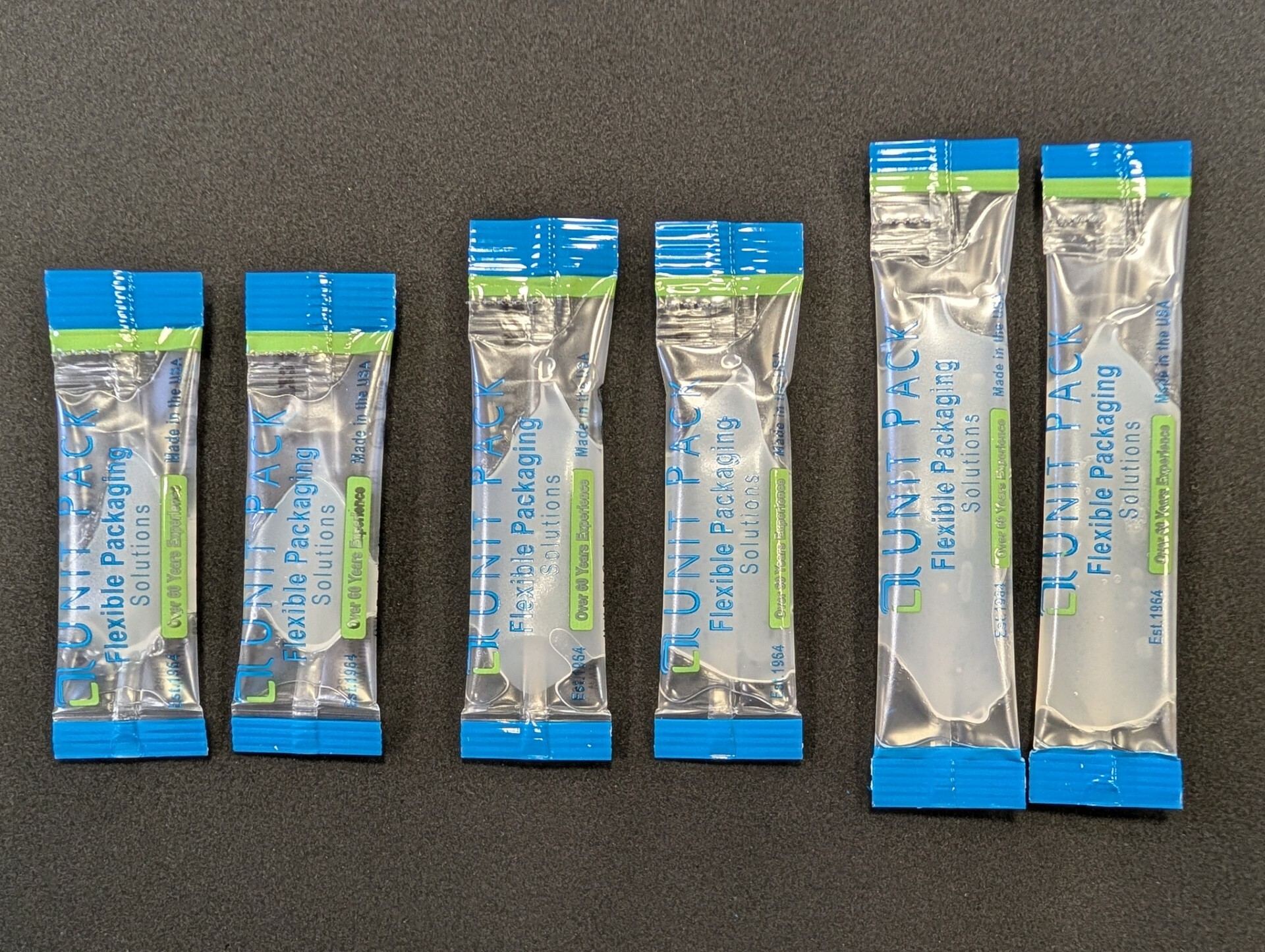 Assorted stick packs for adhesives, cleaners, and lubricants.